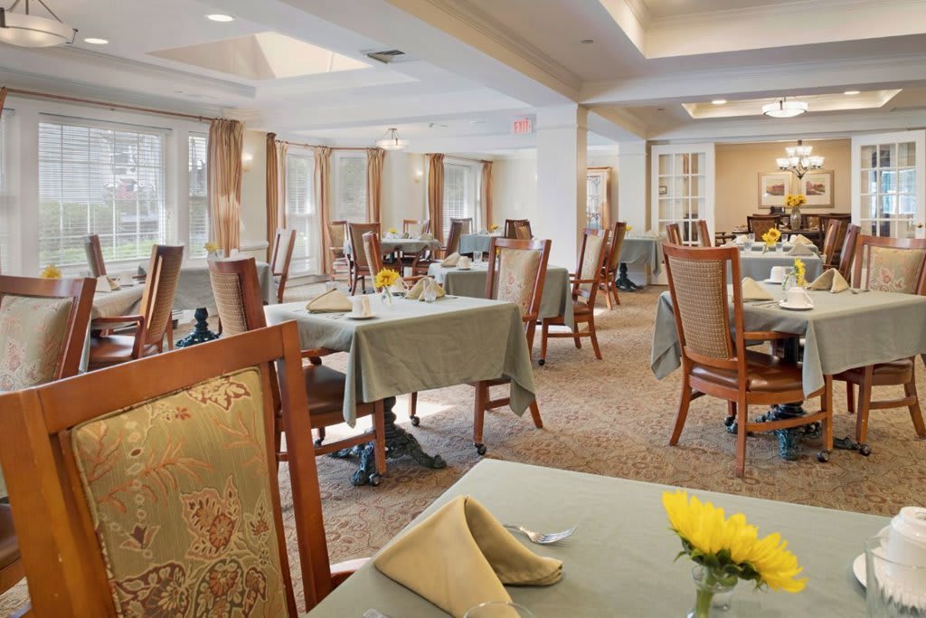 An elegantly designed dining room with neatly arranged tables and chairs in a formal setting.