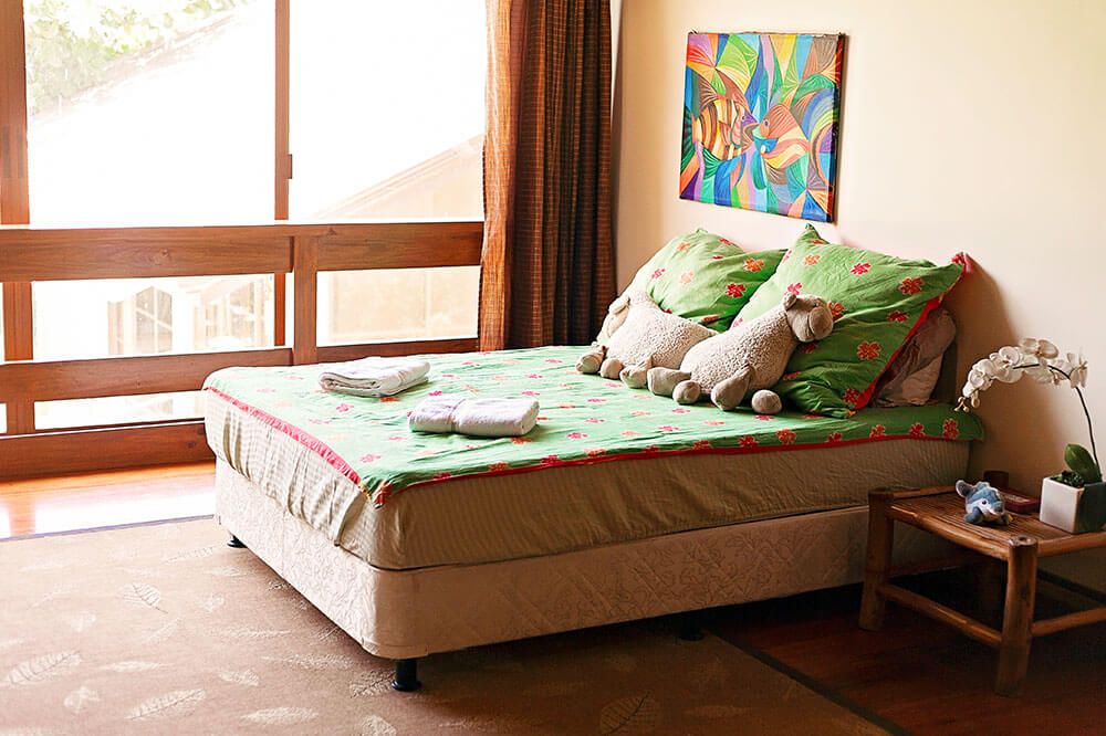 A cozy bedroom with vibrant bedding and playful decor.