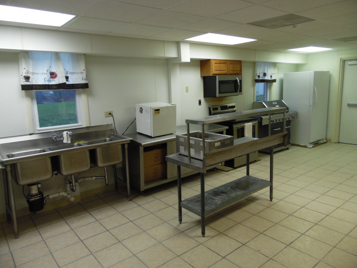 A clean and well-organized commercial kitchen with stainless steel appliances and ample counter space.