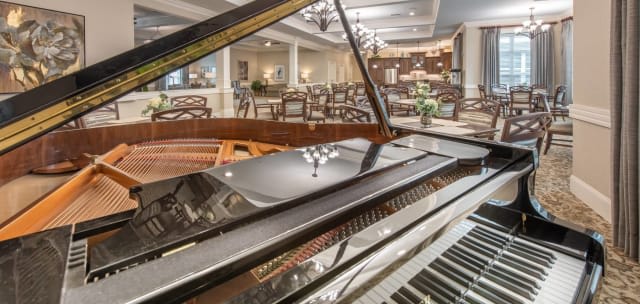 A luxurious restaurant interior with a grand piano in the foreground.