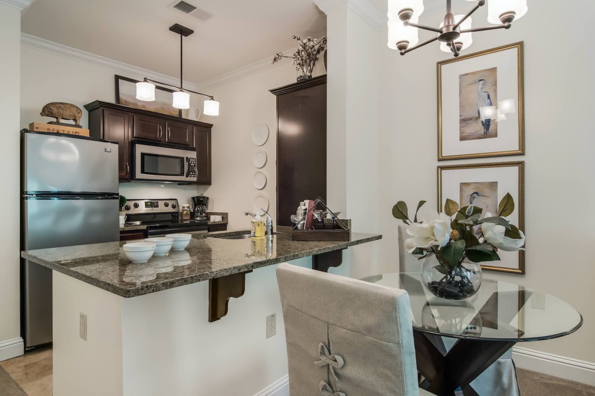 A modern kitchen and dining area with stainless steel appliances, granite countertops, and elegant decor.