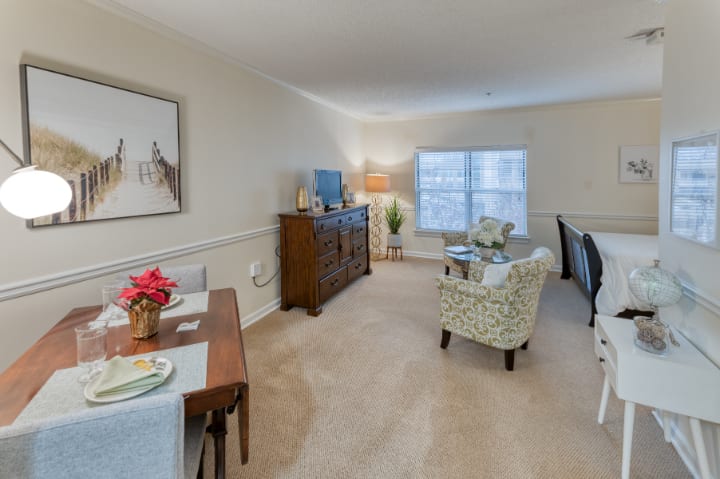 A well-decorated living and dining area with neutral colors and stylish furnishings.