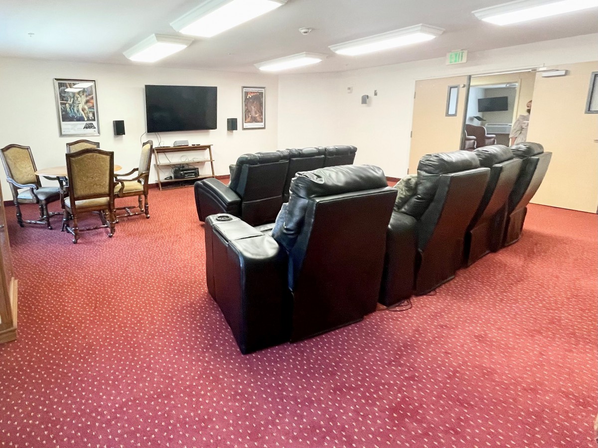 A cozy home theater setup with comfortable seating and a large TV.