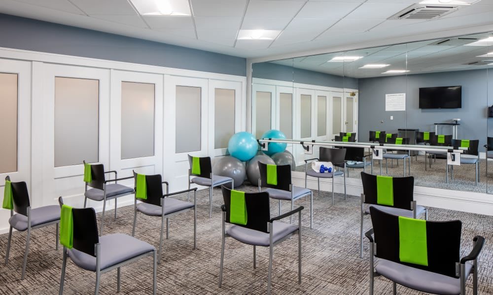 A modern waiting room equipped with chairs and exercise balls.