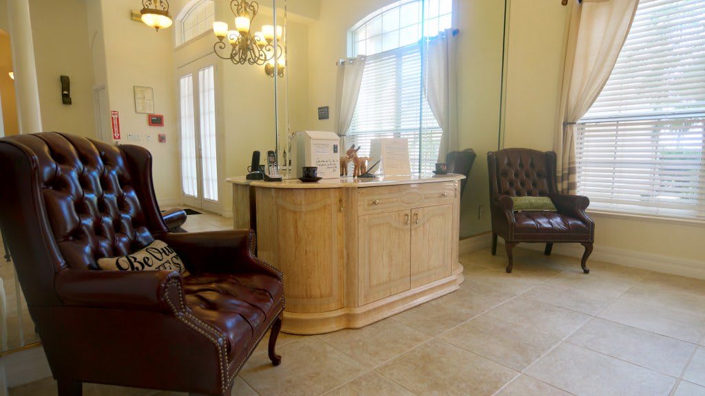 A cozy waiting area with elegant furniture and a coffee station.