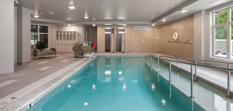 An indoor swimming pool in a recreation or gym facility.