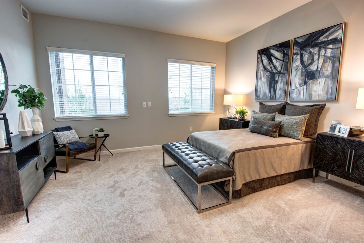 A modern bedroom with elegant furnishings and natural lighting.