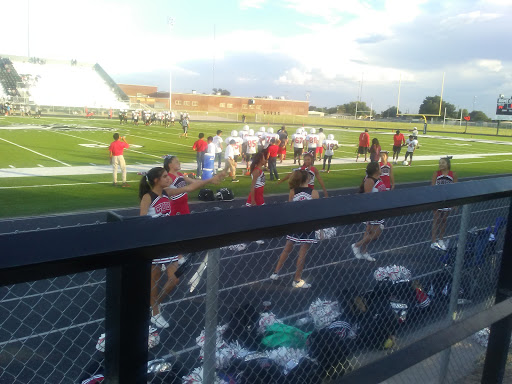 Cheerleaders show their support during a high school football game.