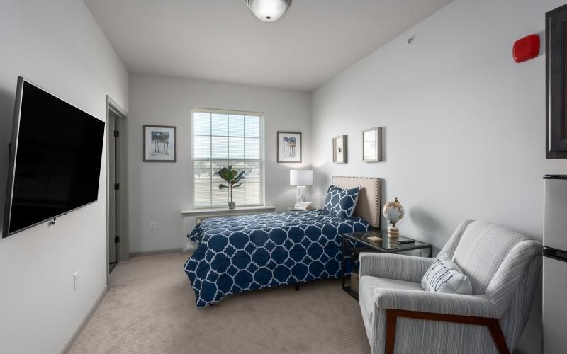 A modern bedroom with a patterned bedspread and elegant decor.