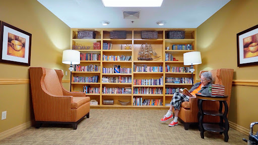 A cozy reading nook featuring a well-stocked bookshelf and comfortable seating.