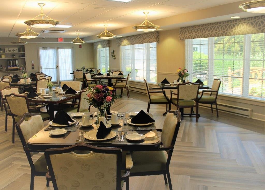 An elegantly decorated dining room with neatly arranged tables and chairs.