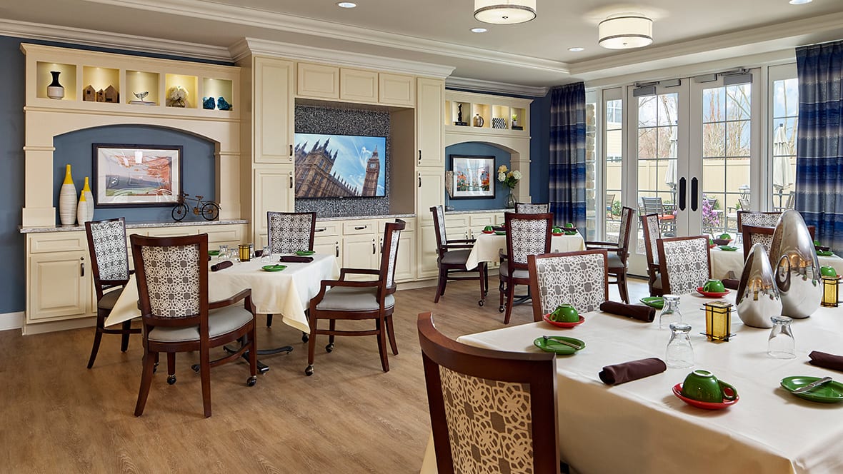 A well-designed dining area with neatly arranged tables and chairs, featuring elegant decor and ambient lighting.