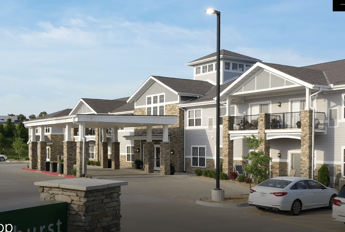 A modern residential building with a spacious driveway and contemporary design.