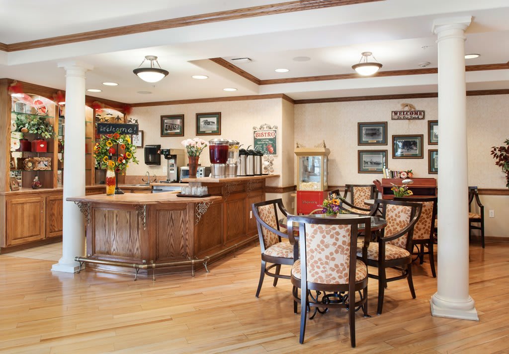 A cozy cafe interior with wooden flooring, tables, and vintage decor.