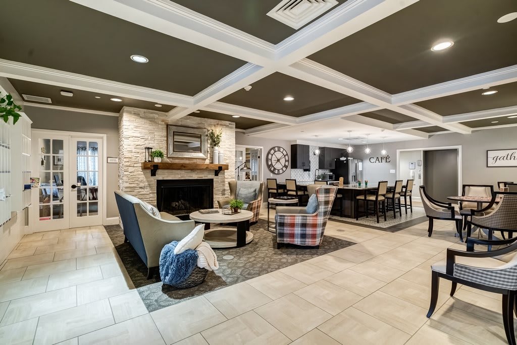 A stylish and modern open-space living room featuring a cozy fireplace, comfortable seating, and elegant interior design.
