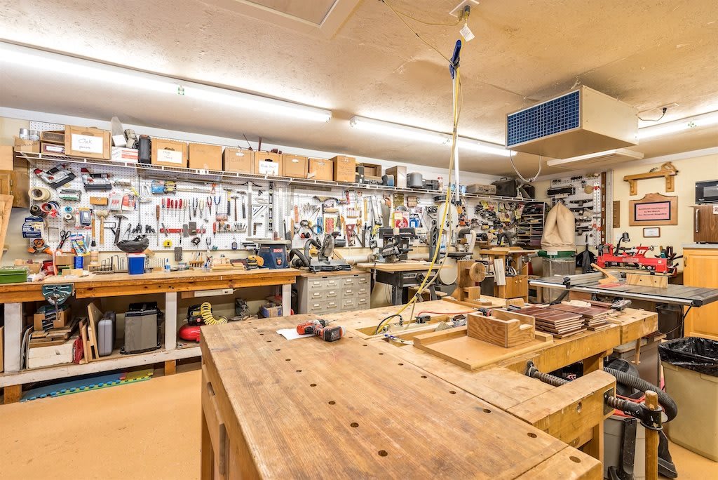 A well-organized woodworking workshop filled with various tools and equipment.