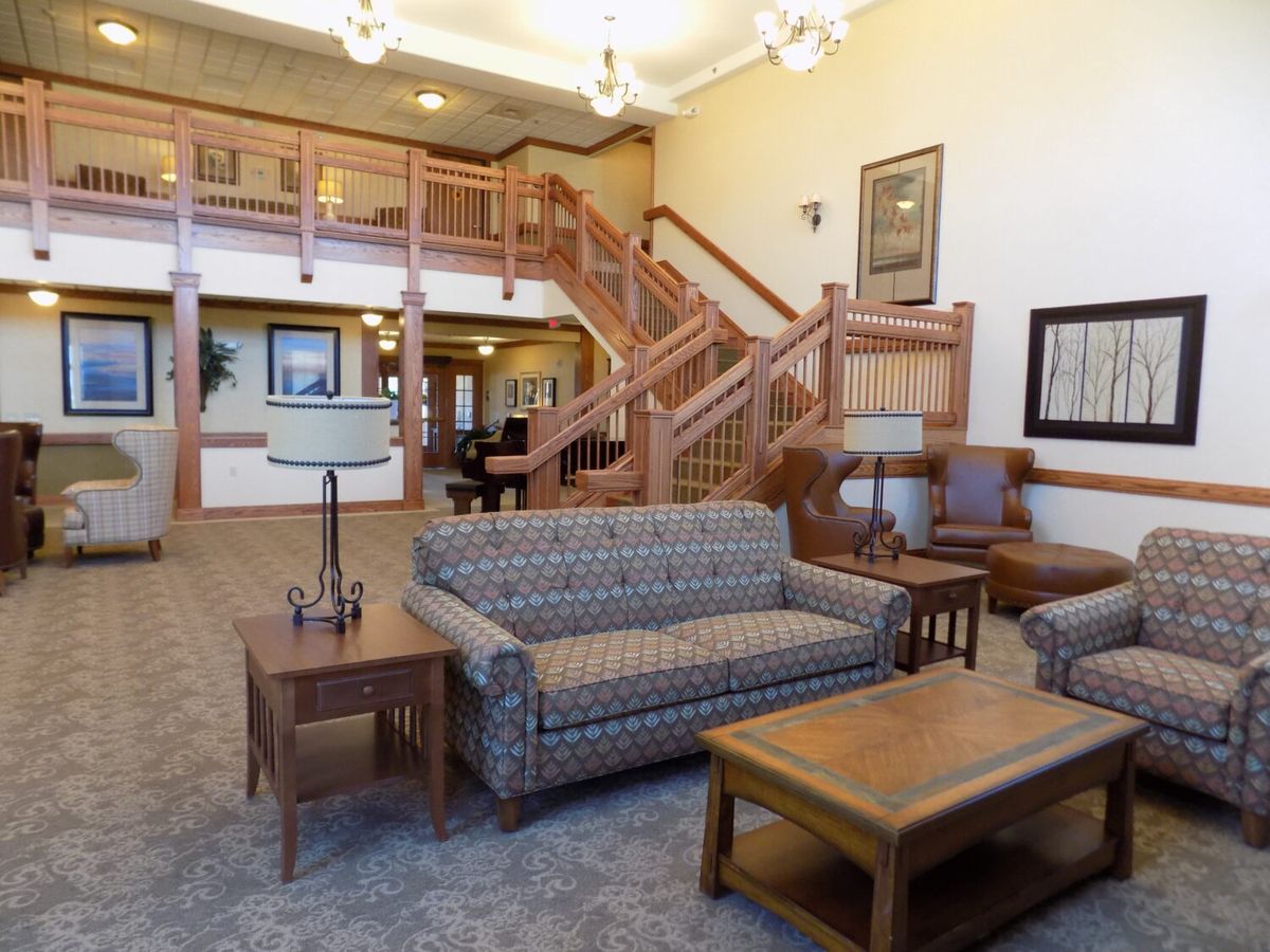 A cozy lobby area with comfortable seating and a grand staircase.