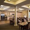 A modern kitchen and dining area with ample seating and contemporary lighting.