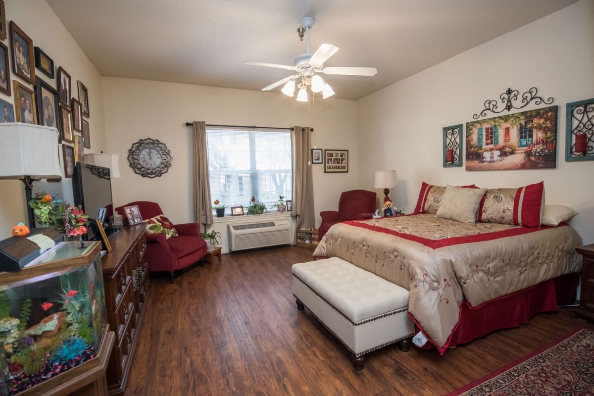 A cozy bedroom with elegant decor and hardwood flooring.
