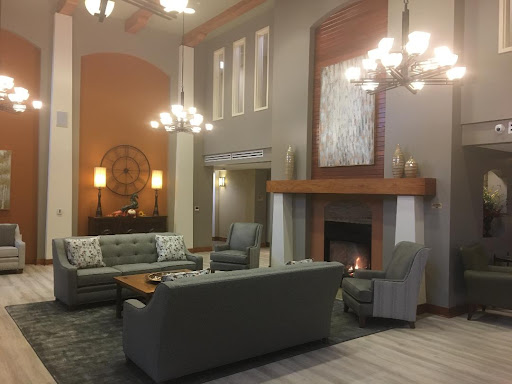 A cozy and elegantly designed lobby space featuring modern furnishings and a warm fireplace.