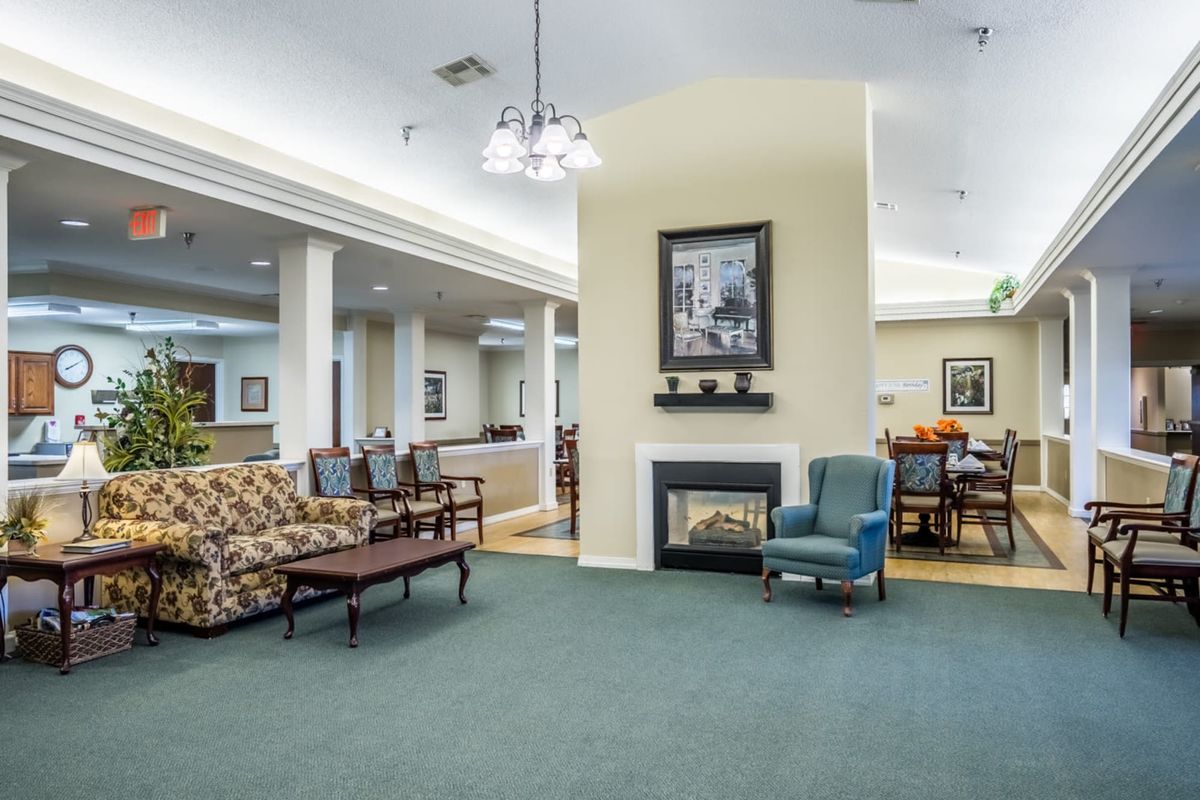 A cozy community living room with comfortable seating and a fireplace.