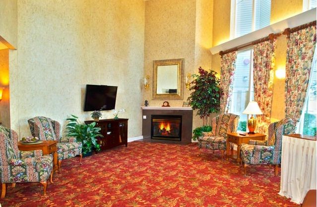 A cozy living room with a fireplace, television, and comfortable seating.