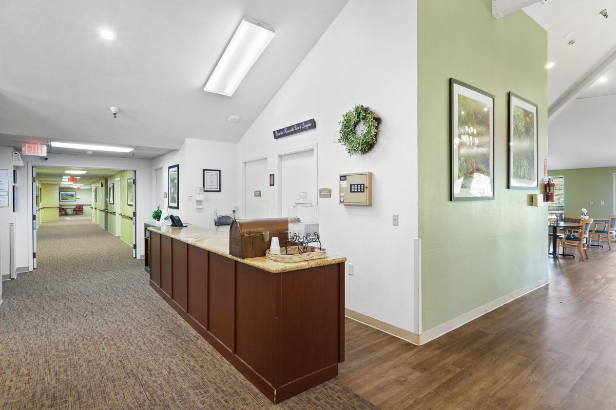 A reception area with a desk and hallway in an office setting.