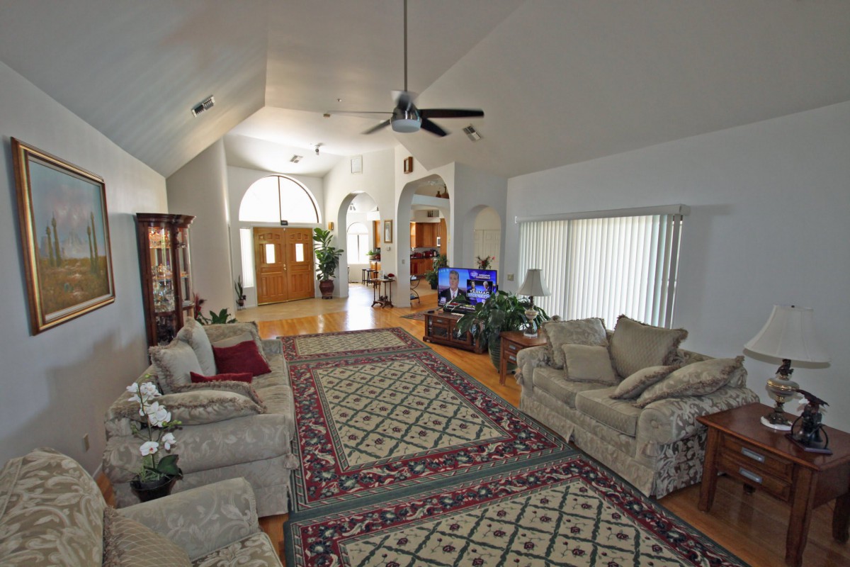 Spacious living room with comfortable seating and a large carpet.