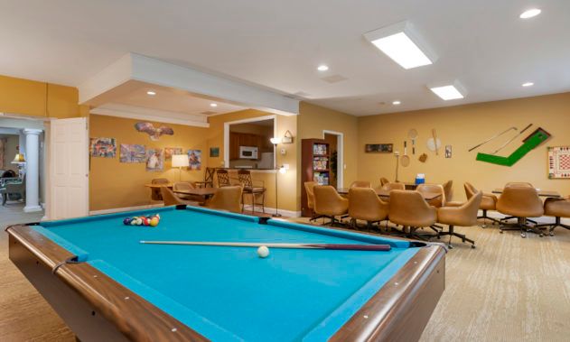 A cozy recreation room featuring a pool table and comfortable seating area.