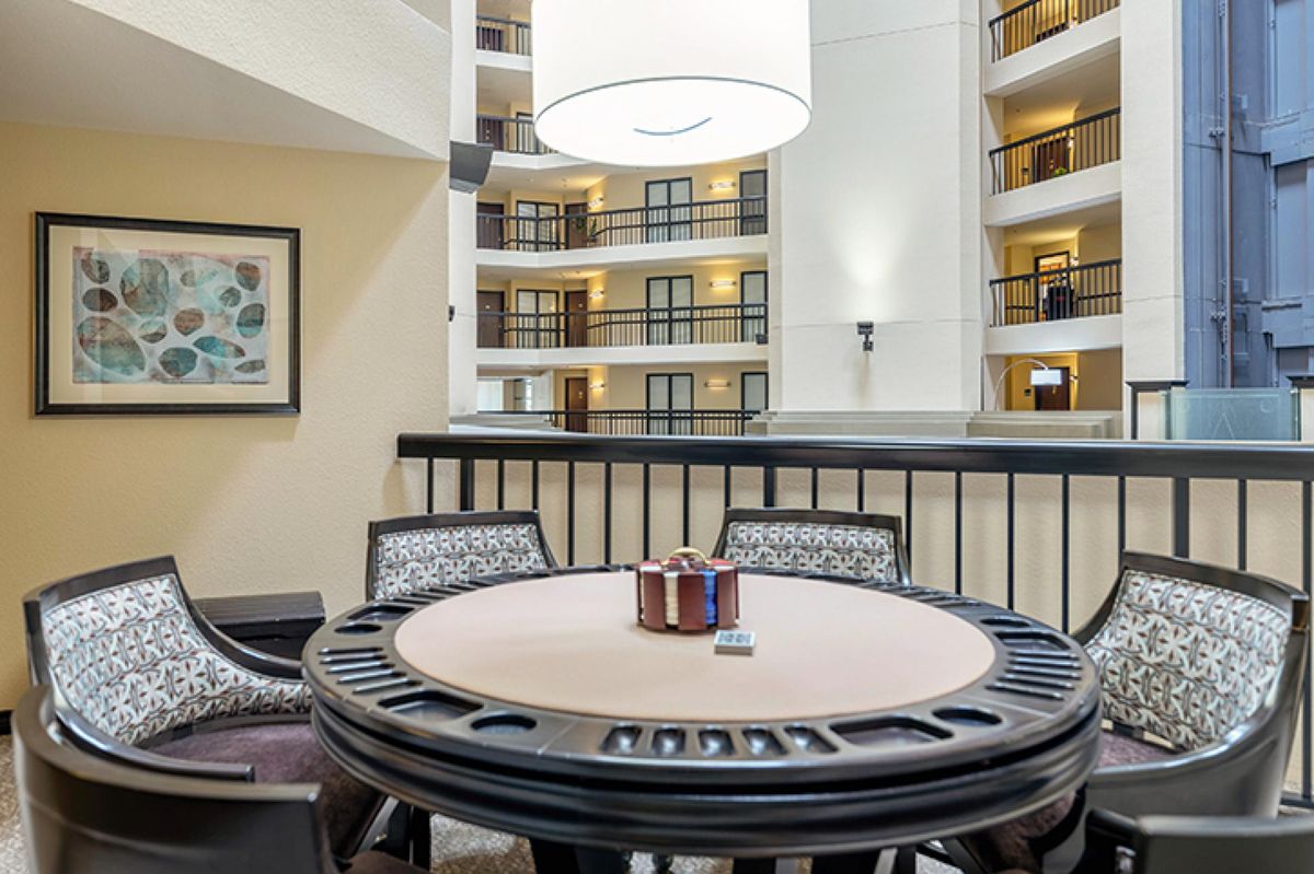 A table with poker chips in a hotel atrium setting.