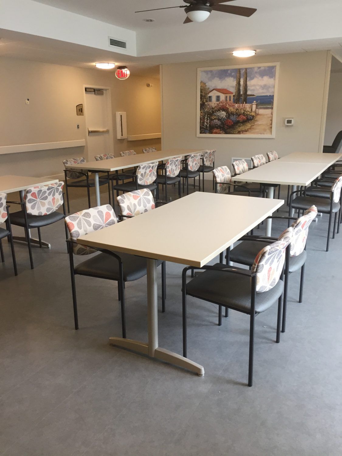 An empty dining room with arranged tables and chairs.