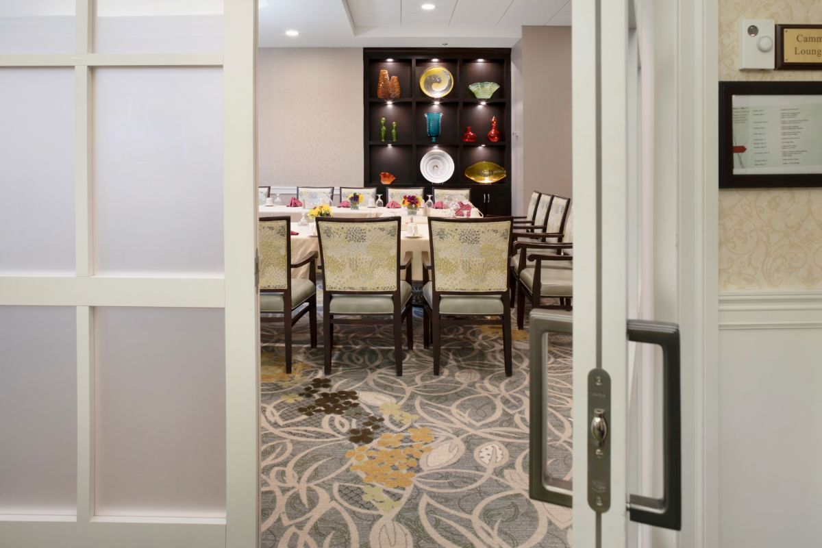 A sophisticated dining room with decorative plates on display.