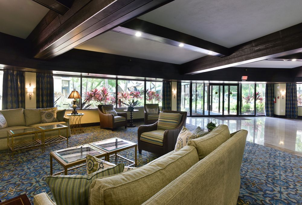 A modern, spacious lobby area with comfortable seating and large windows allowing natural light.