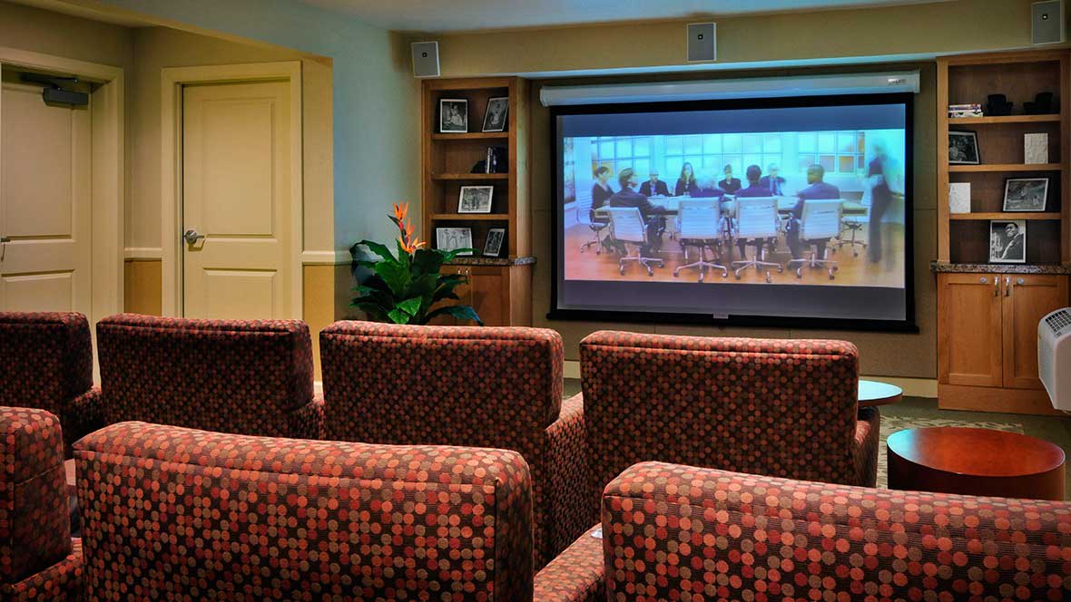 Cozy home theater setup with a projector screen and comfortable seating.