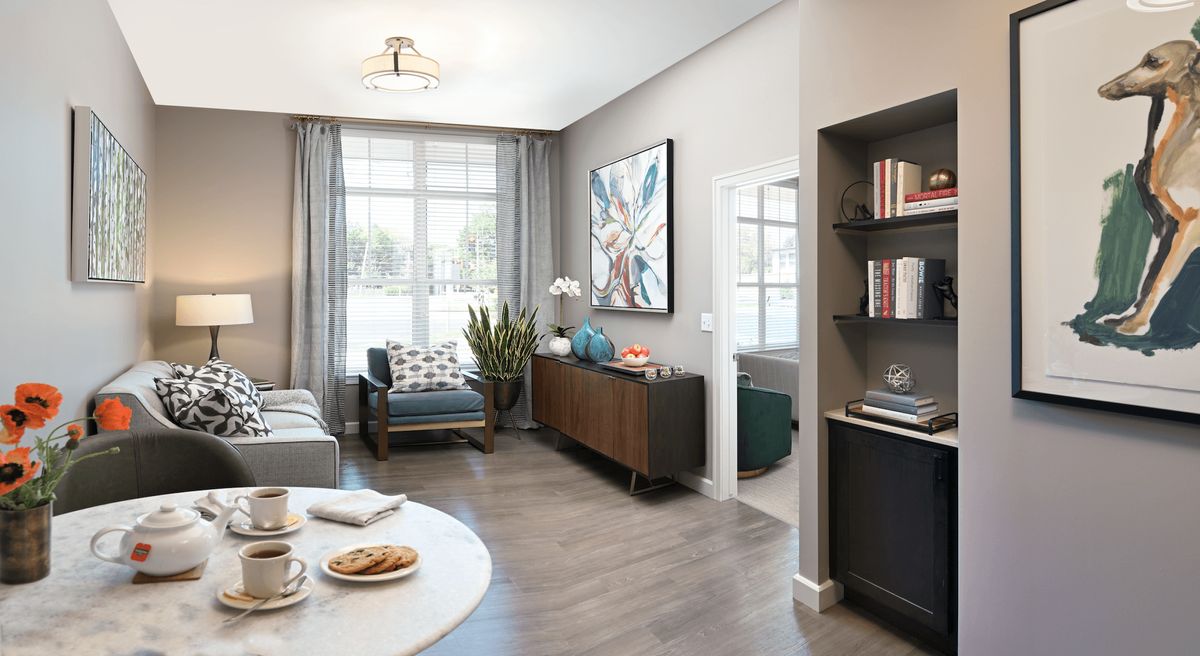 A modern living room with stylish furniture and large windows providing ample natural light.