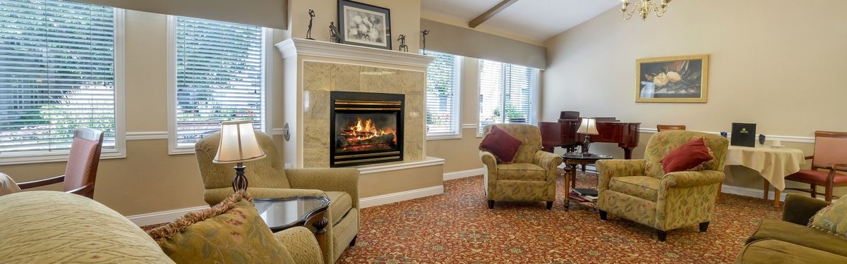 A cozy living room with a fireplace and comfortable seating.