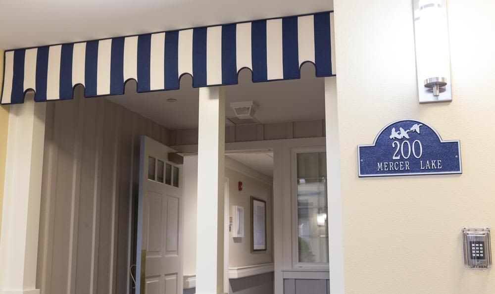 An interior hallway with a blue and white striped awning above the entrance.
