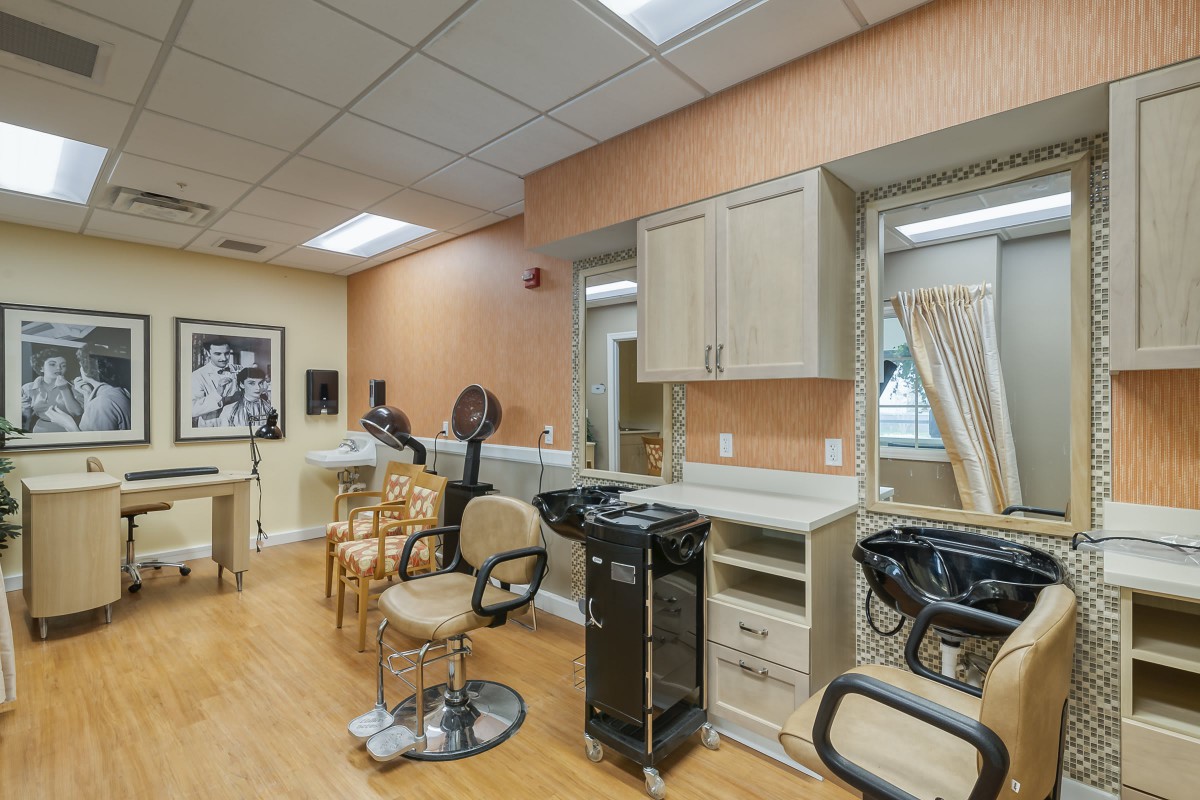 A well-equipped salon interior featuring hairdressing chairs and styling stations.