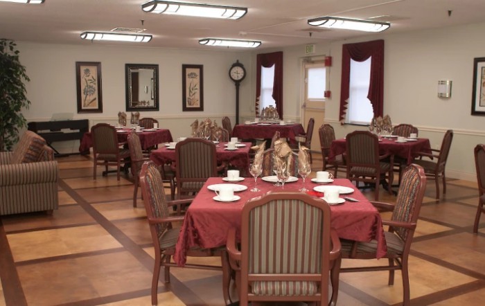An elegant dining room with neatly arranged tables and chairs, ready for guests.