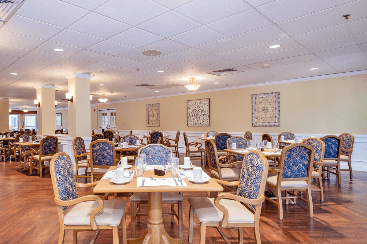 An elegant dining area with neatly arranged tables and chairs.