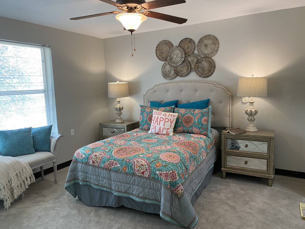 A cozy bedroom with colorful bedding and stylish decor.