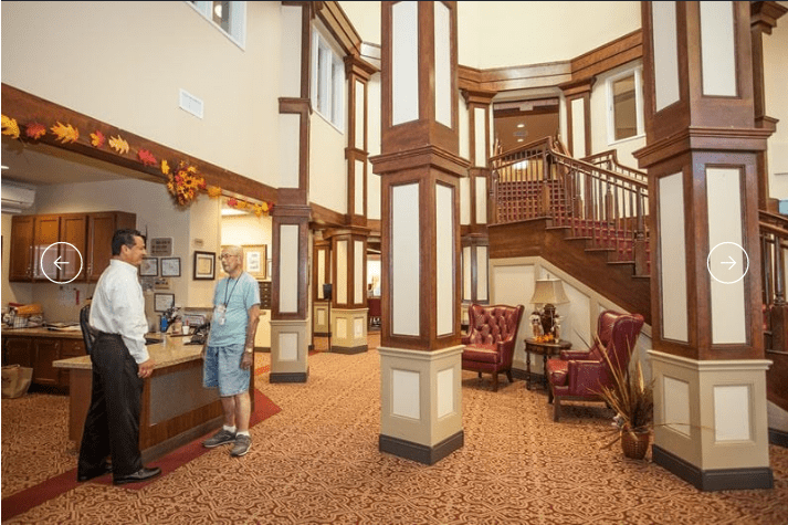 A classic hotel lobby with elegant wooden interiors and a reception desk.