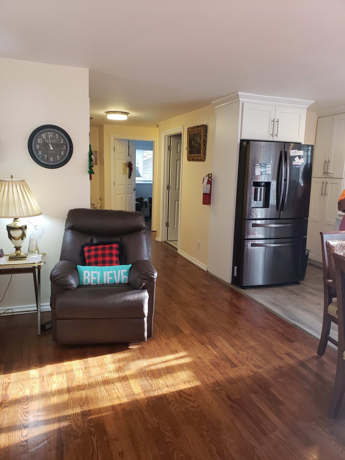 A cozy living area with a comfortable chair and adjacent kitchen space.