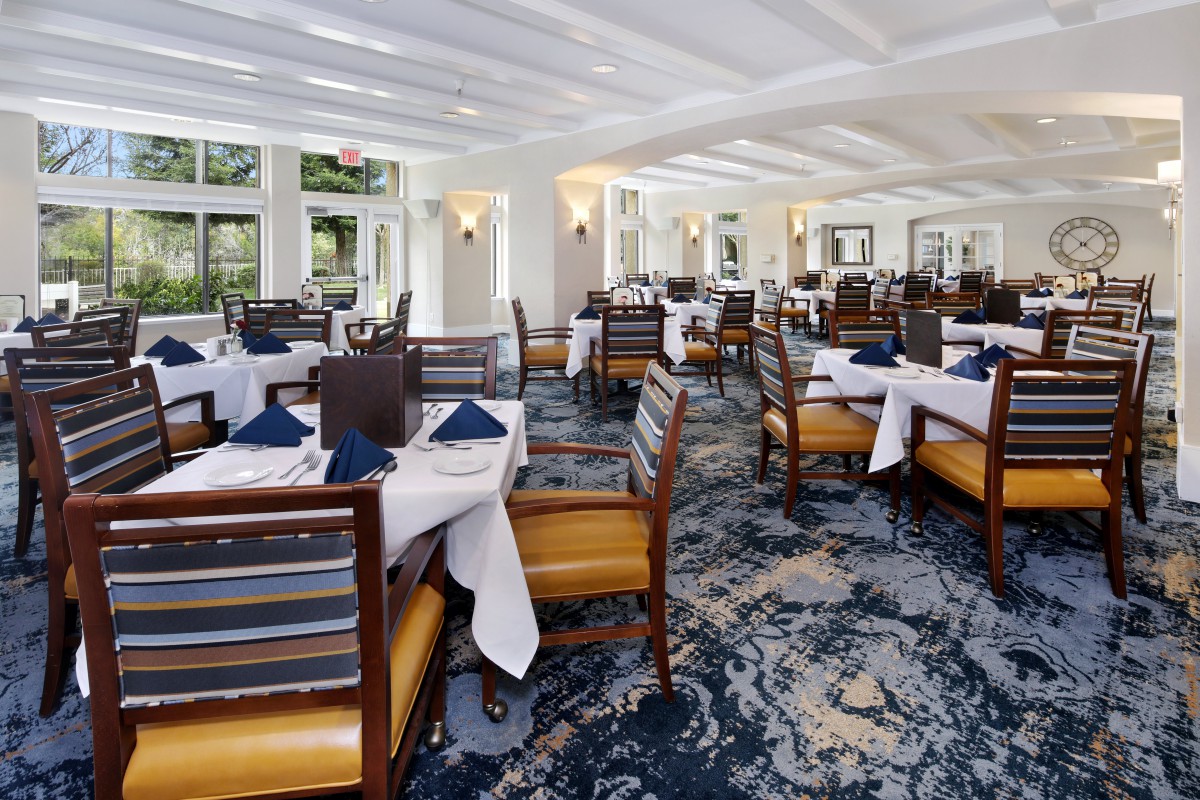 An elegant restaurant interior with neatly arranged tables and chairs.