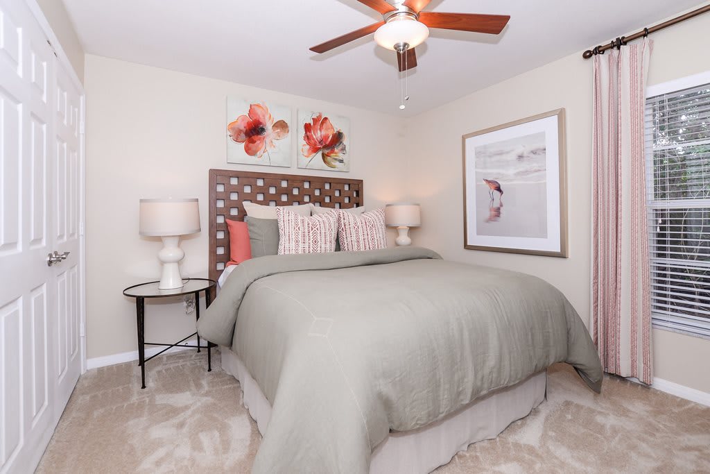 A modern bedroom with stylish decor, featuring a comfortable bed, lamps on side tables, and eye-catching artwork.