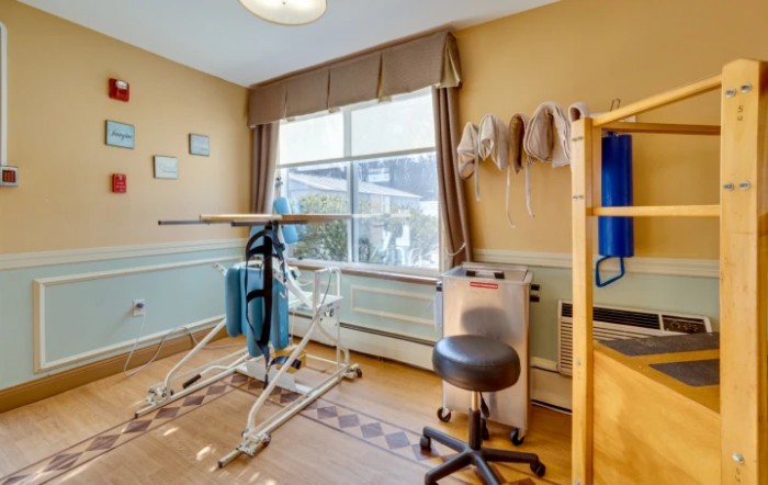 A well-equipped physical therapy room with exercise and rehabilitation equipment.