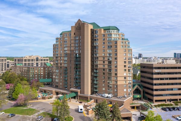 A tall residential apartment building in an urban setting.