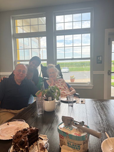 A warm family gathering with smiles shared over a table.