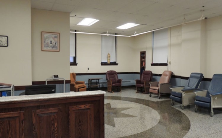 A quiet waiting room with comfortable chairs arranged around the space.