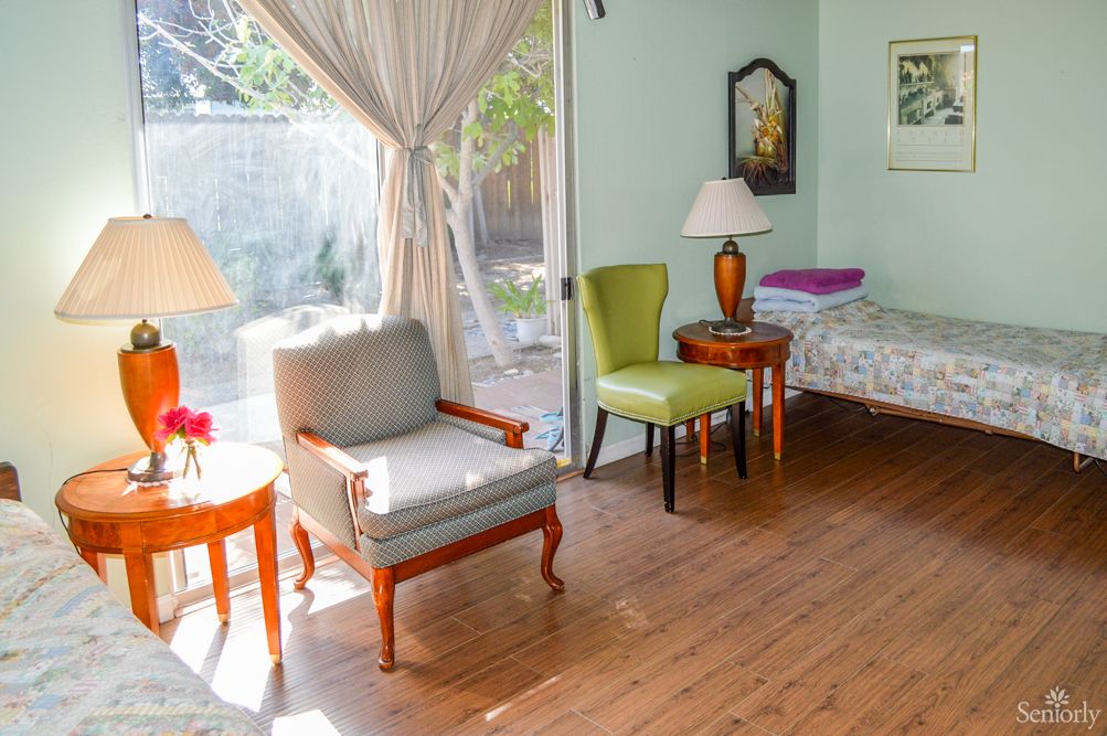 A cozy living room with elegant furniture and ample daylight.